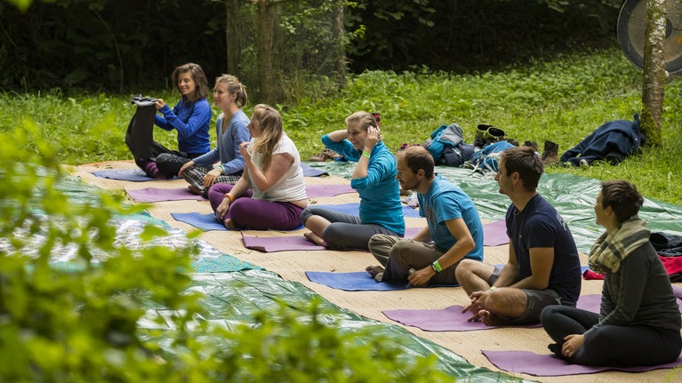 Yoga instructor leading outdoor classes during the South West Outdoor Festival, Heddon Valley, Devon